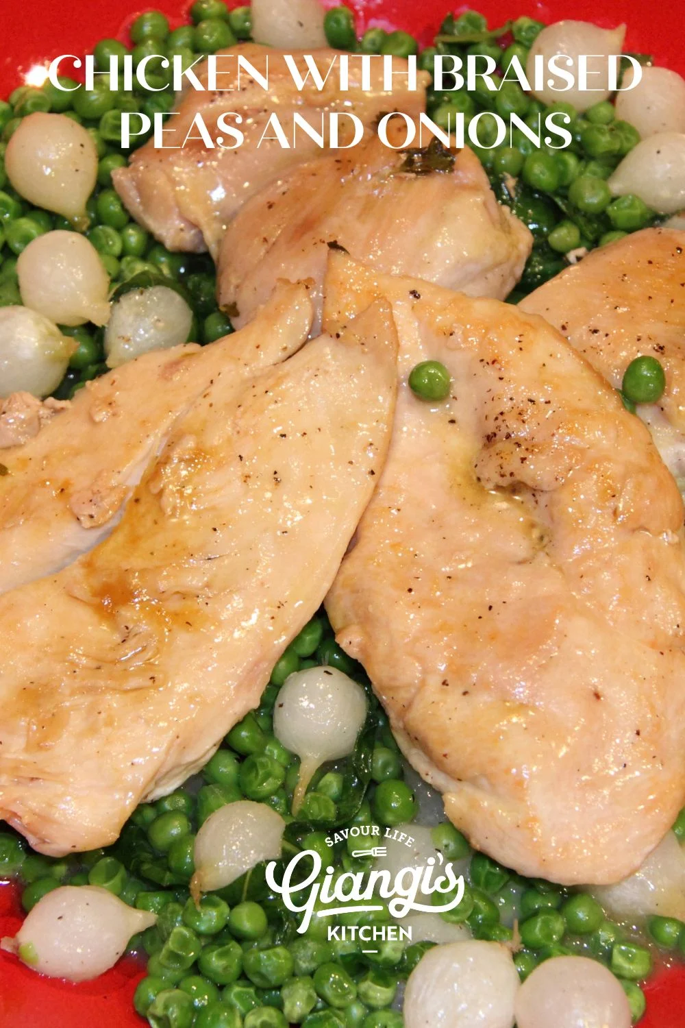 Chicken with braised peas and onions served in a red serving dish.