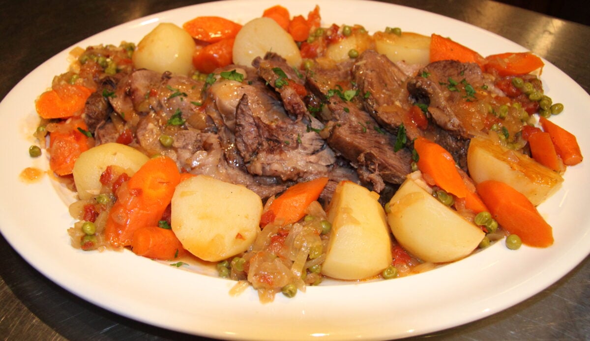 Pot roat with vegetables served with potatoes and carrots alongside