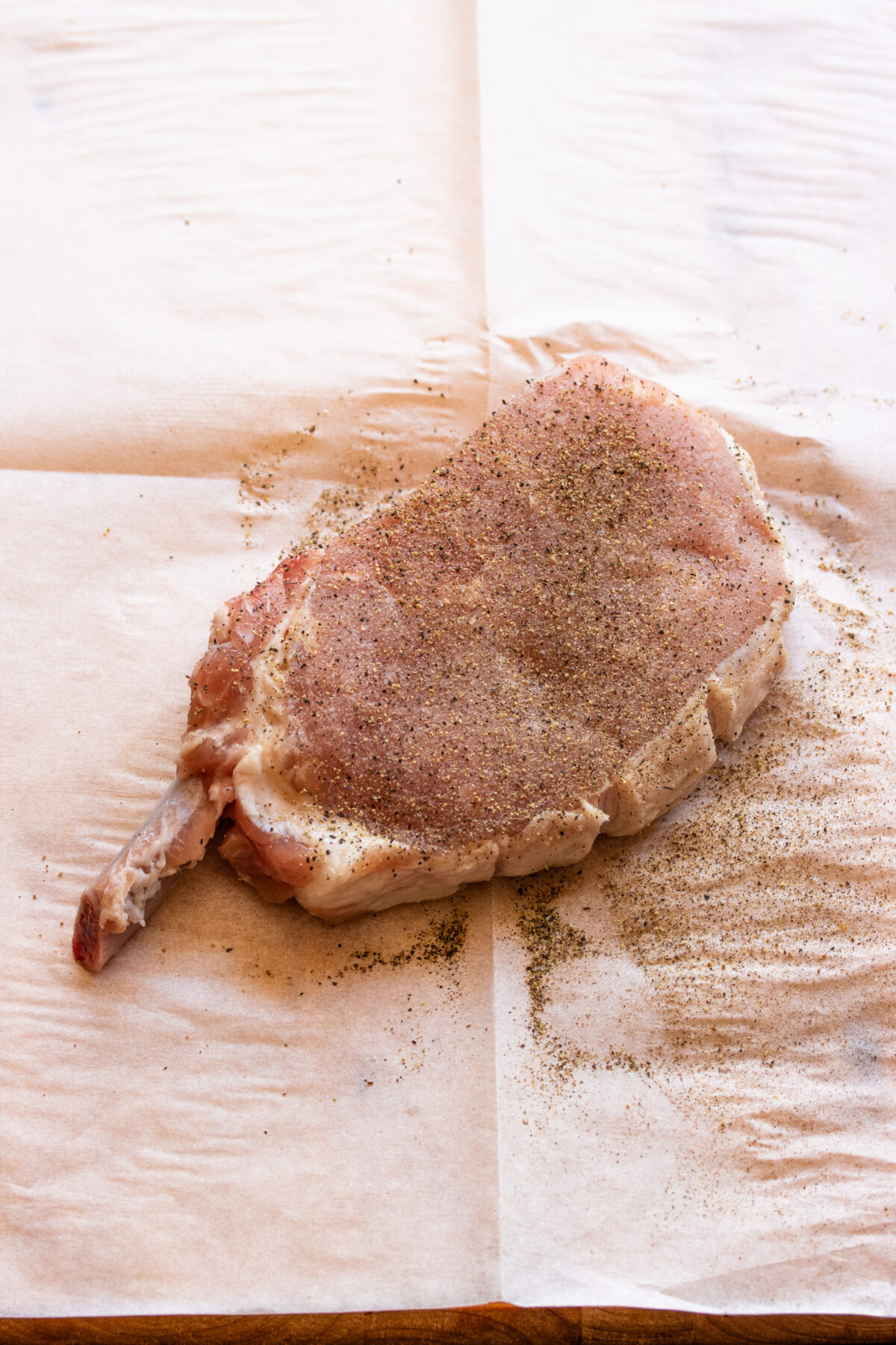 Generousely season pork chop with salt and black pepper.