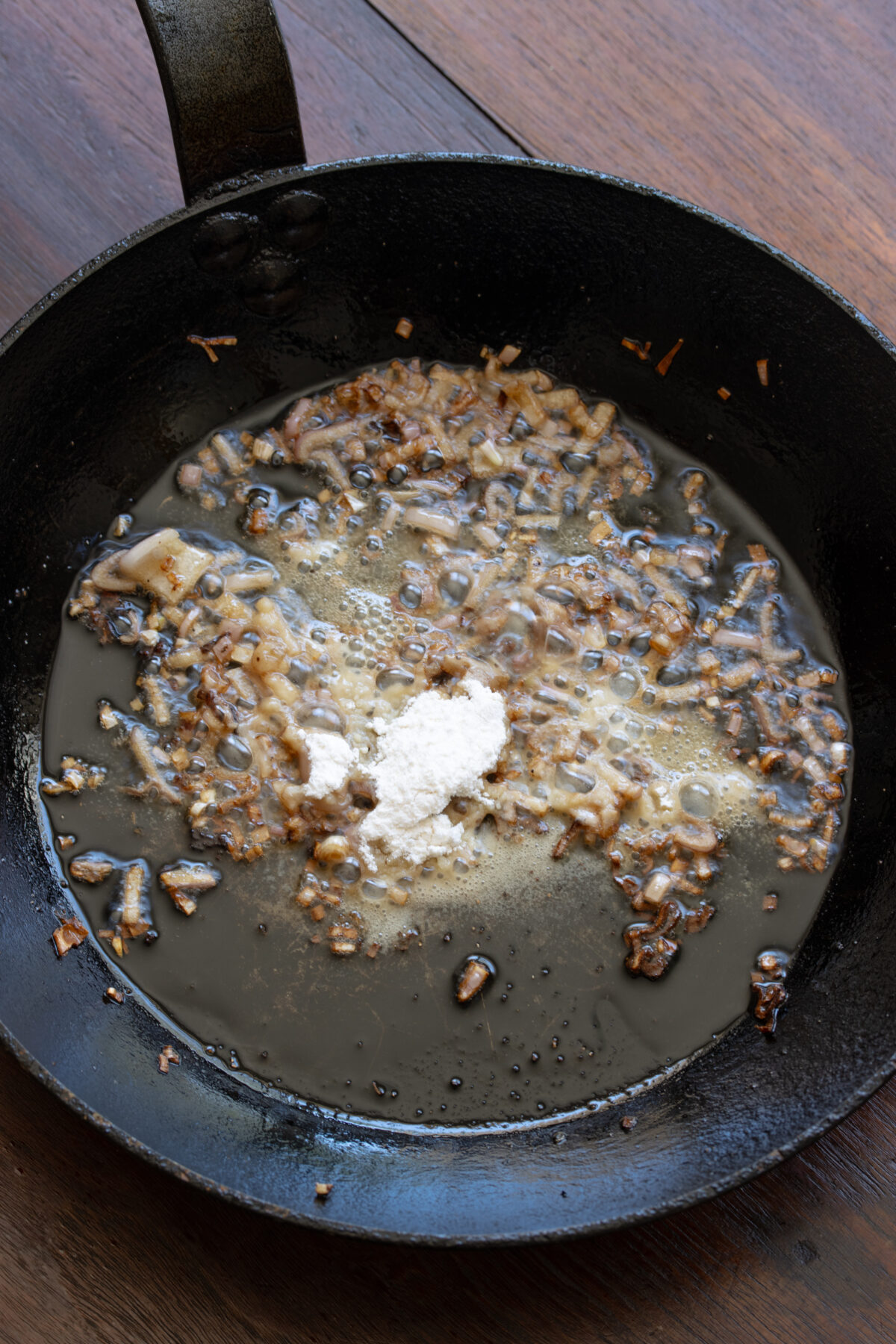 Flour added to the skillet with the shallots