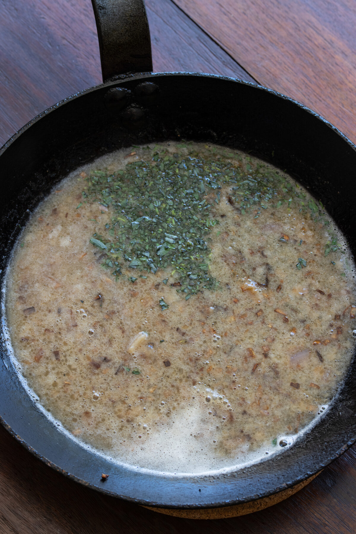 Tarragon is added to the skillet with the beer, chicken broth, maple syrup
