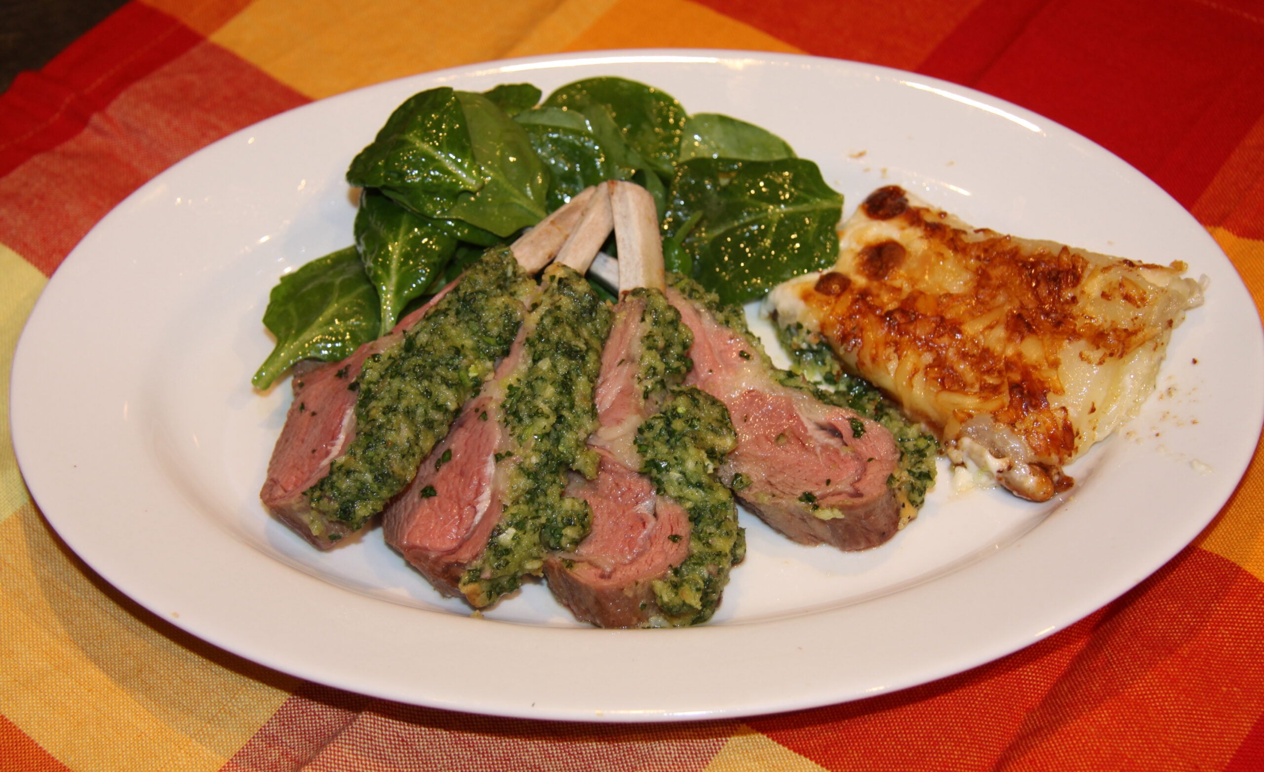 lamb ribs fanned on a white plate