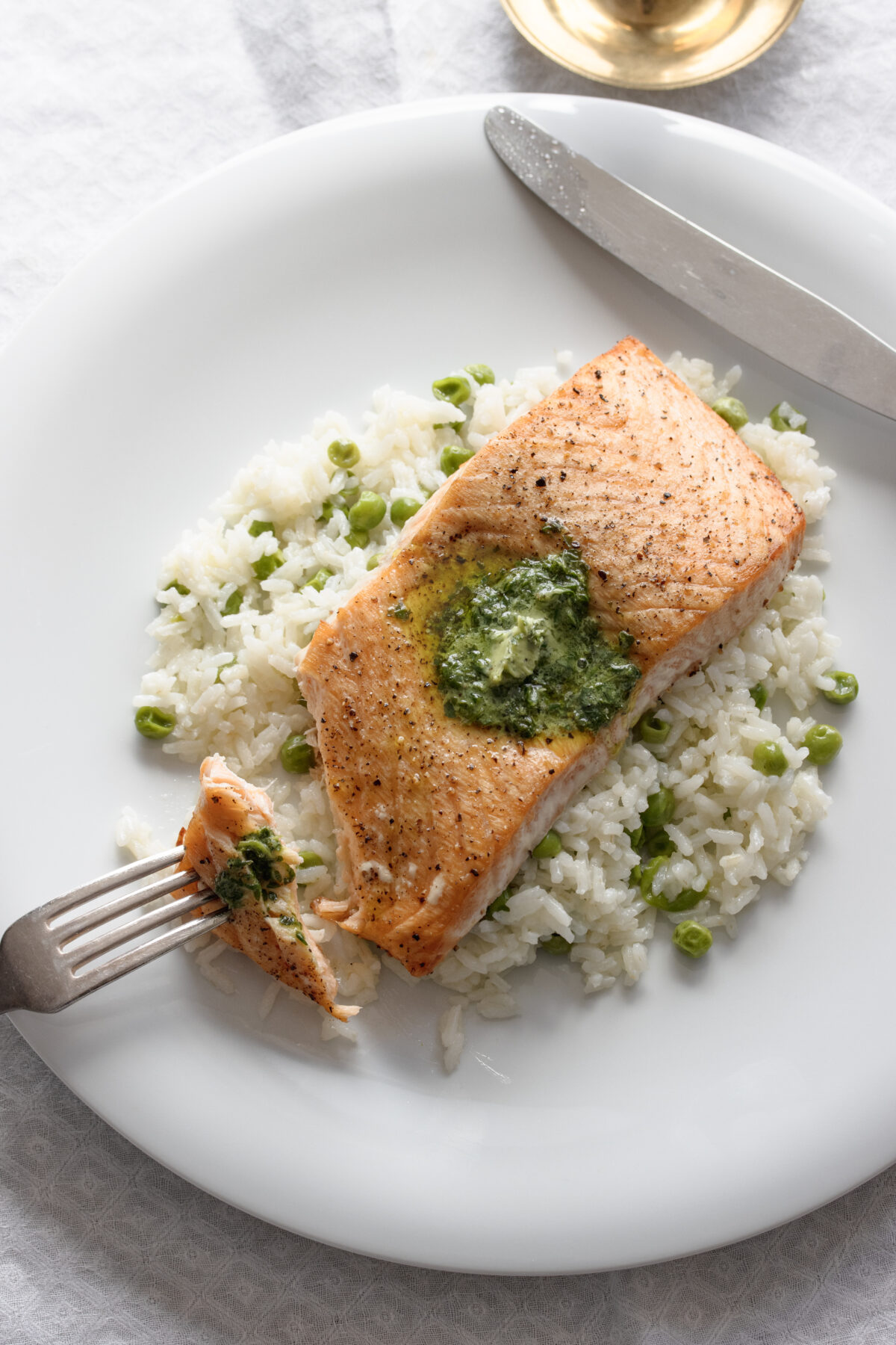 Ready to be enjoyed baked salmon topped with beurre maitre d'hotel, 