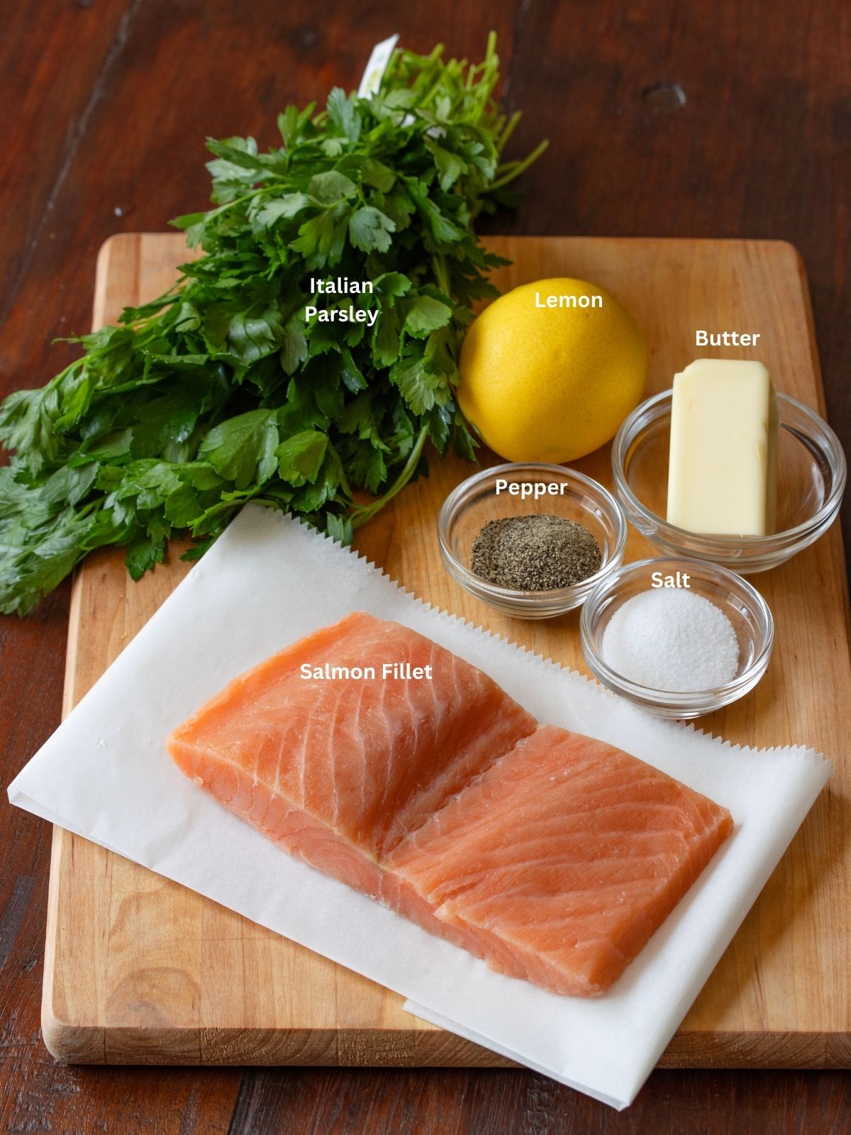 Ingredients needed to make this salmon maitre d' hotel, placed on a cutting board. 