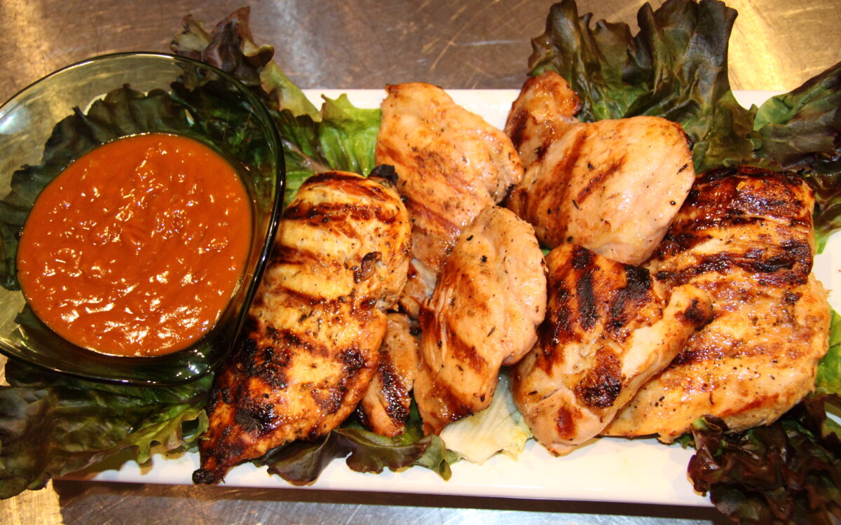 Lemon Chicken with satay sauce served in a rectangular white serving plate.