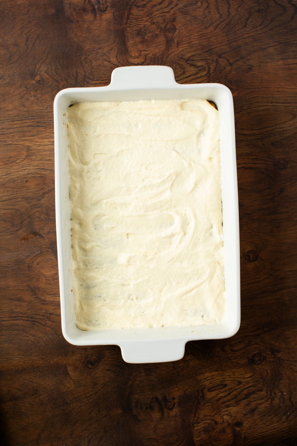 A layer of mascarpone is placed over the coffee soaked ladys fingers to create the first layer of your tiramisu. 