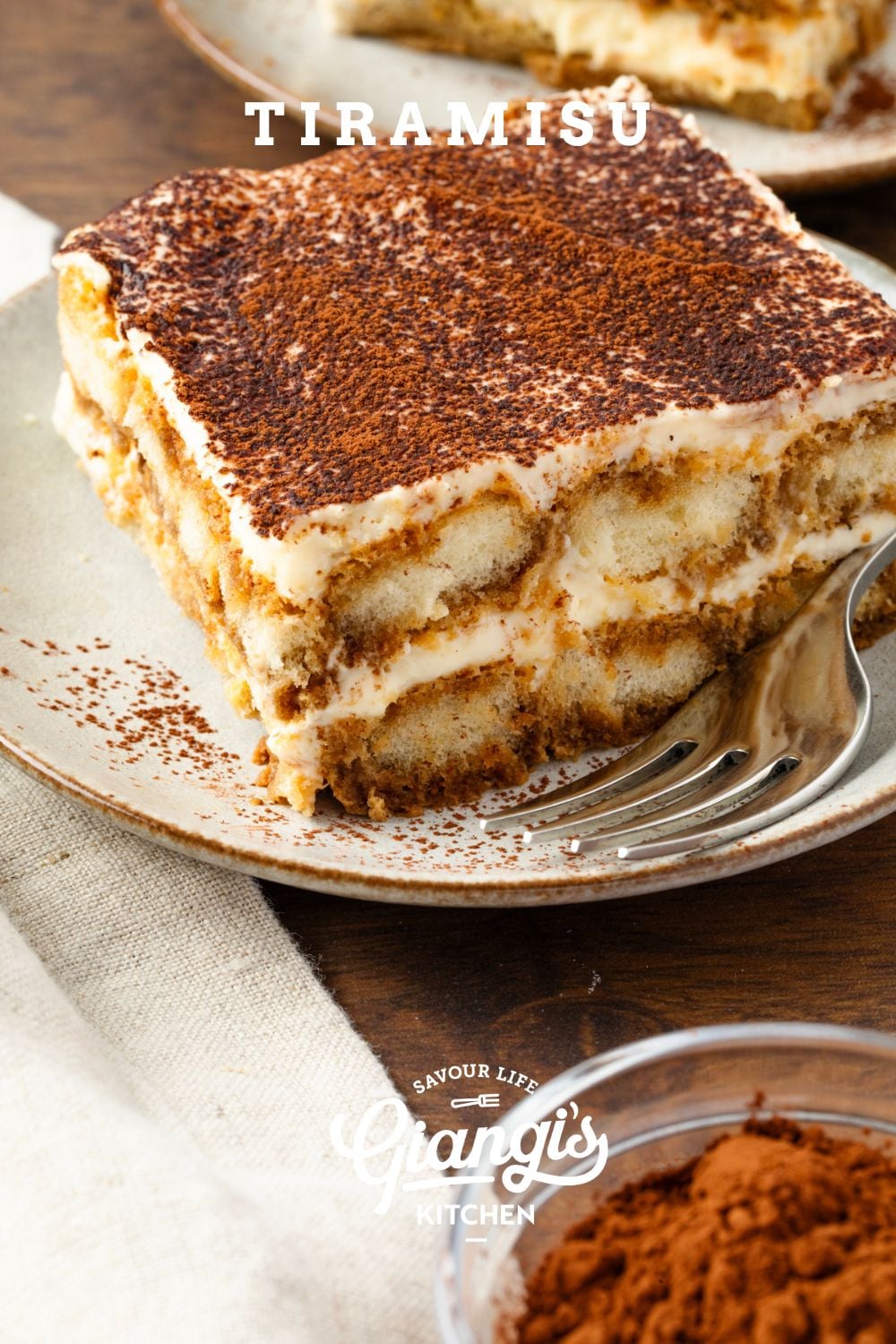 Slice of tiramisu served on a dessert plate.