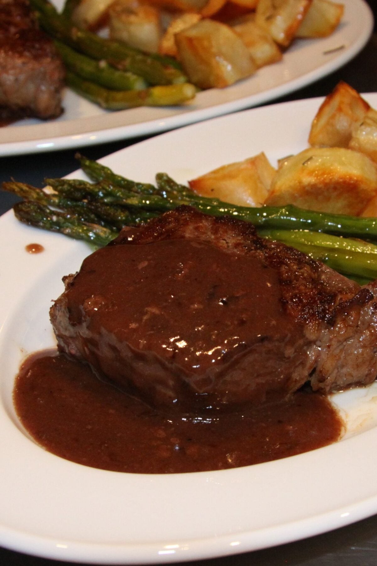 New York steak with wine souce served with asparagus and roasted potatoes