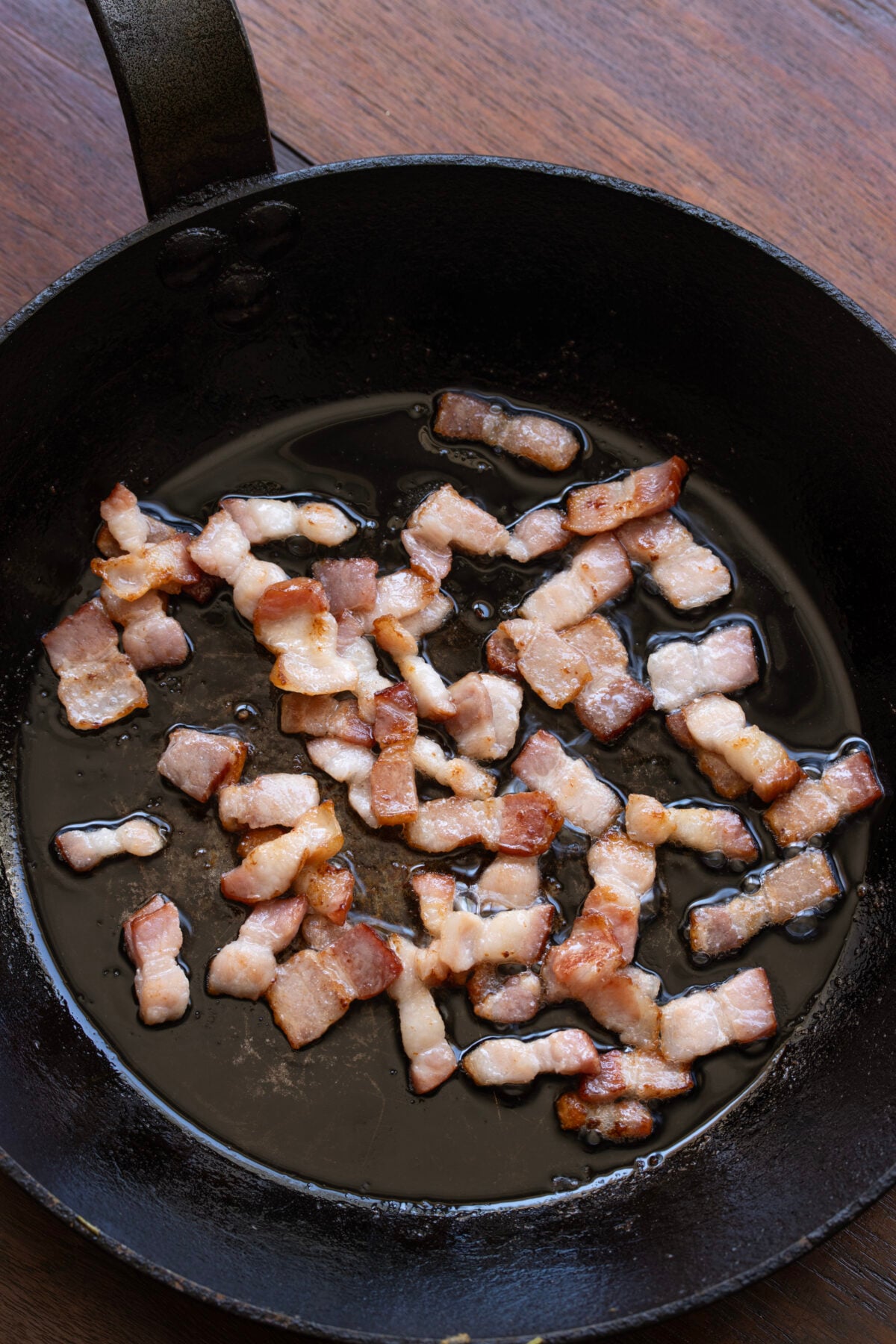 In a large skillet, cook bacon over medium-high heat until golden brown and crispy.
