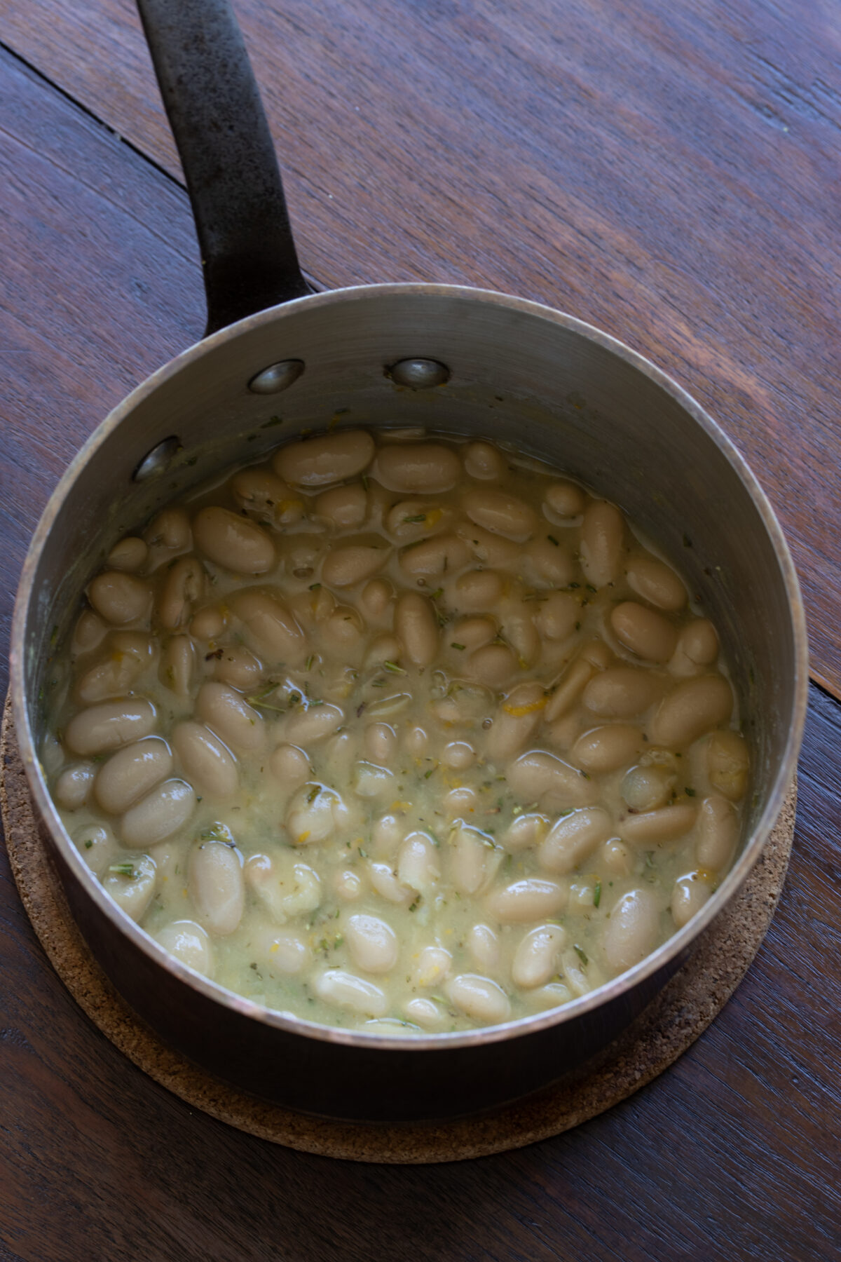 Cooking the white beans in a small pan.