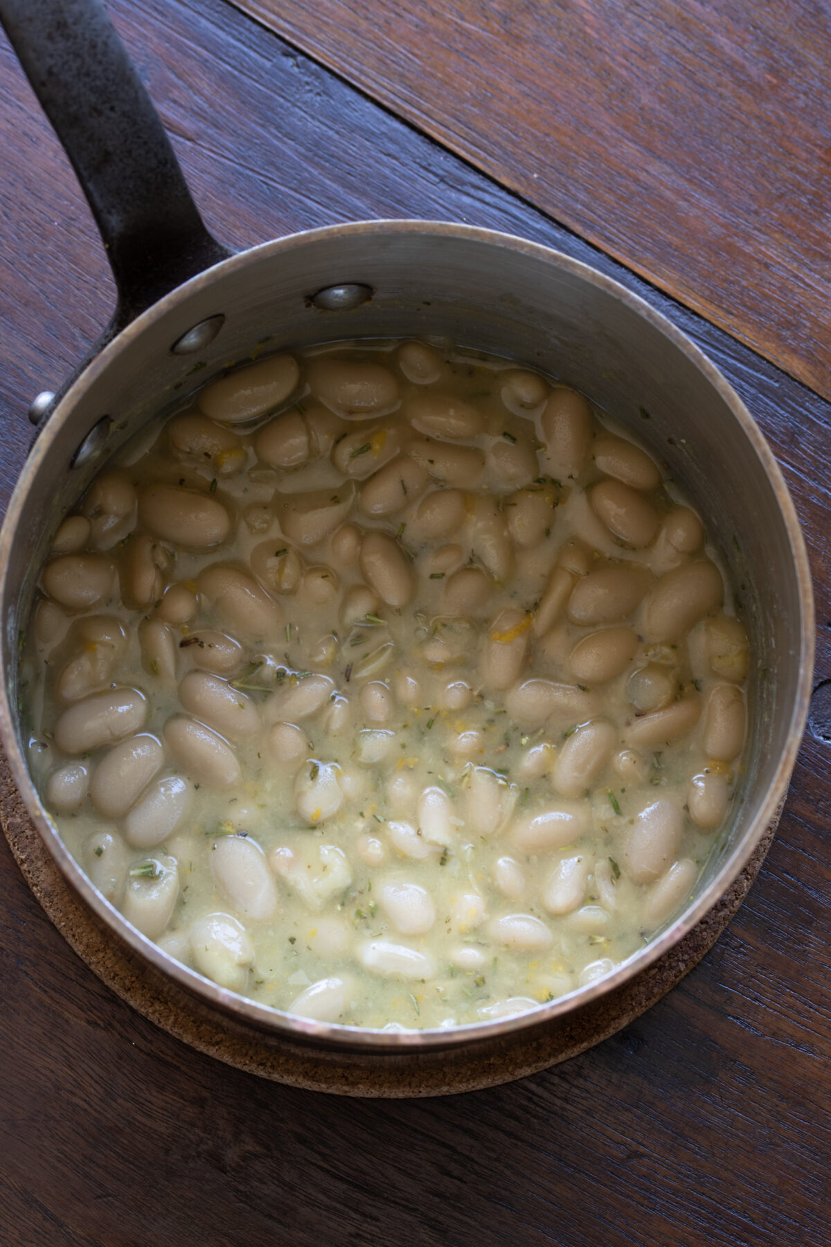 Cannellini white beans are done in a small pan.