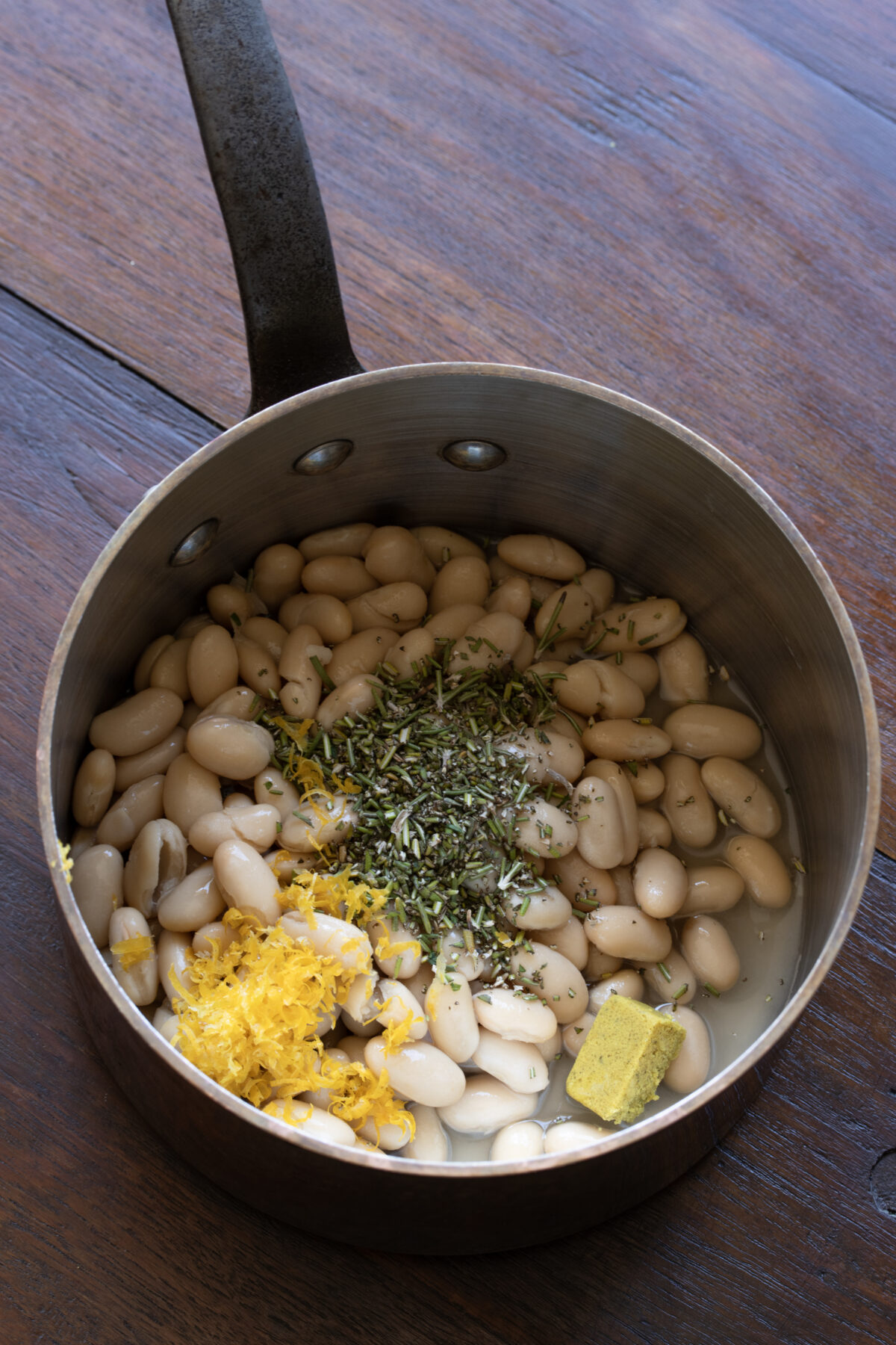 Ingredients for the white bean rosemary ragout all assembled in a pan.