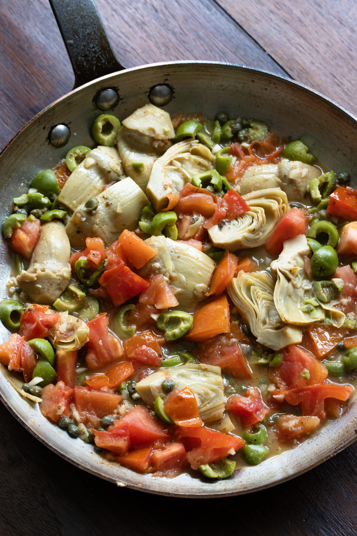 Tomatoes are tender and remaining butter is added to the skillet. 