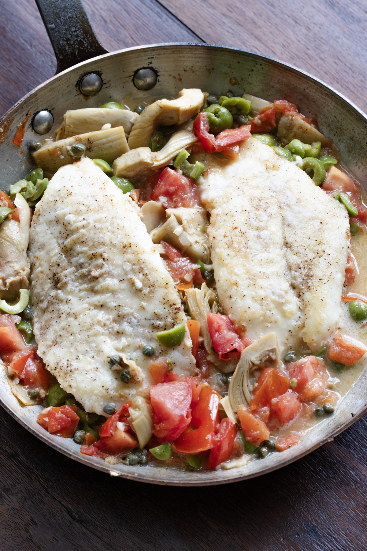 Cod is returned to the skillet with all the vegetables.