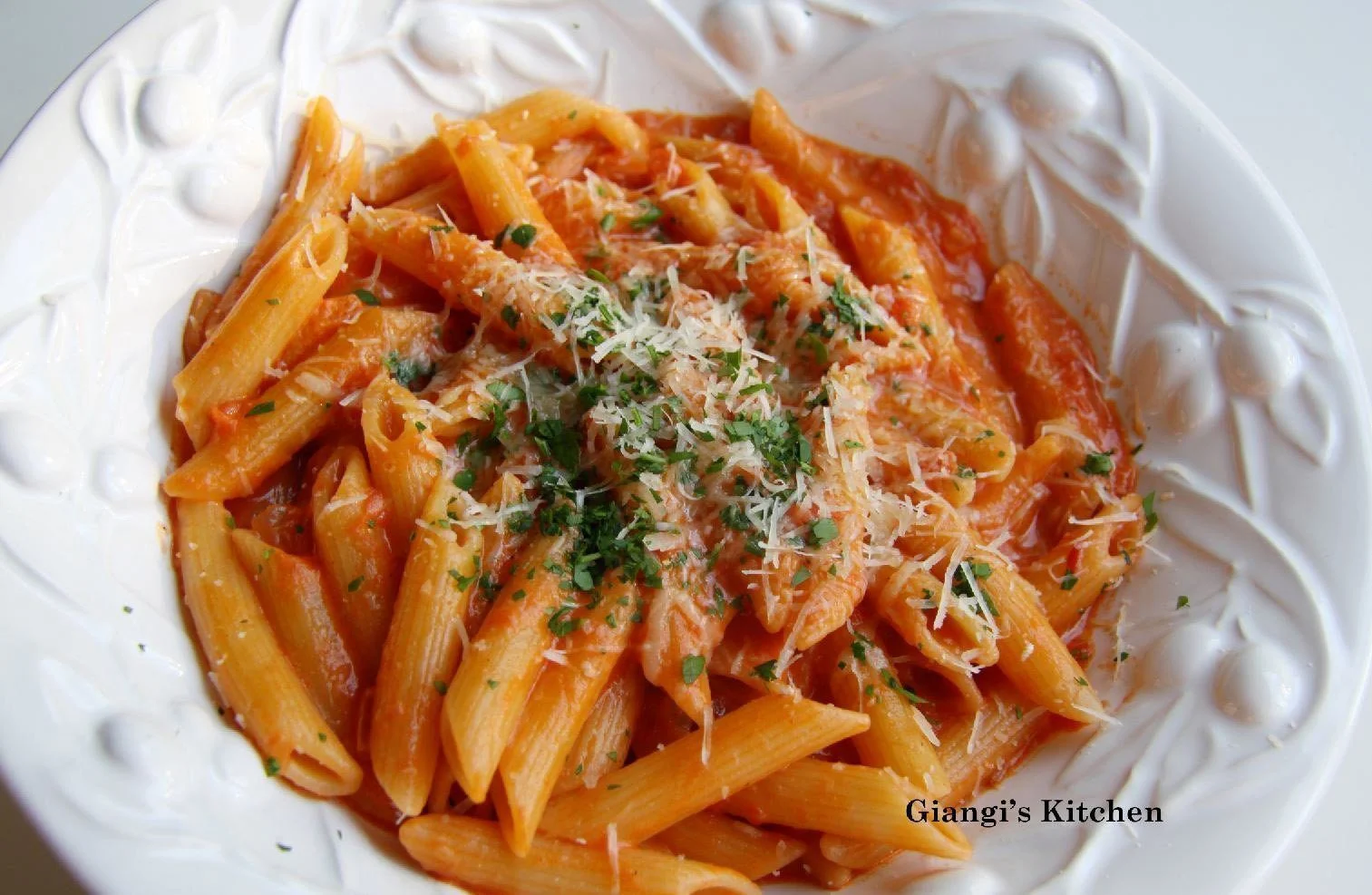 Penne alla vodka in a white serving plate