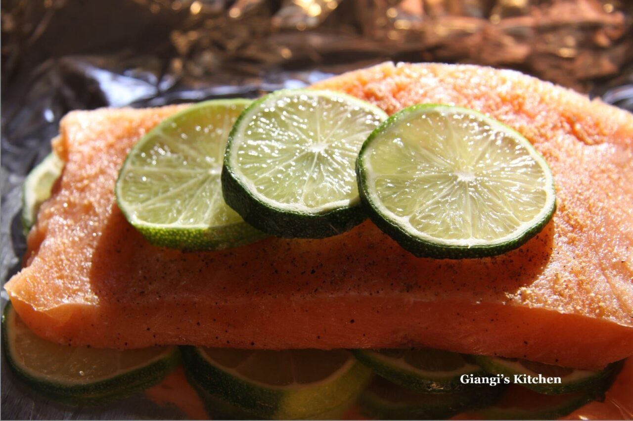 Salmon Fillets with Baby Greens and Arugula Salad with lime over it
