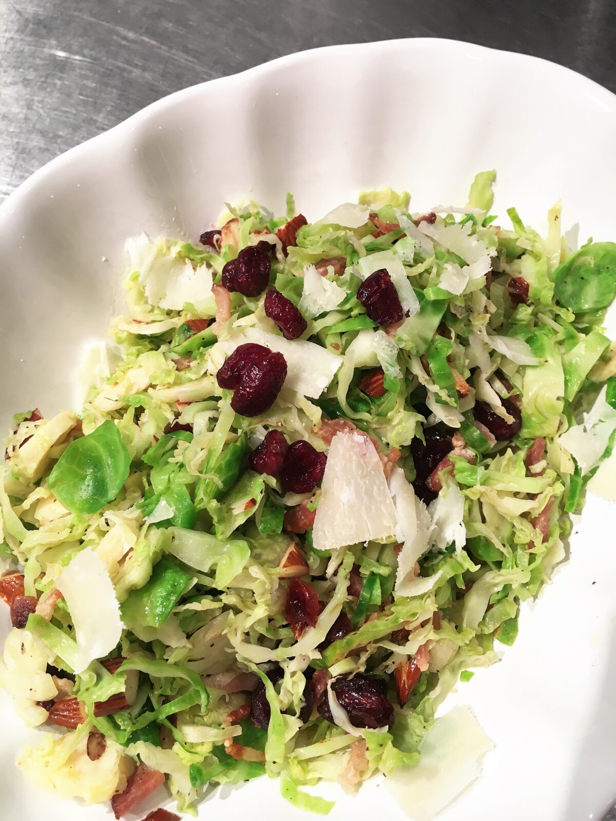 Brussels Sprouts with Almond, Bacon and Cranberries in a serving plate.
