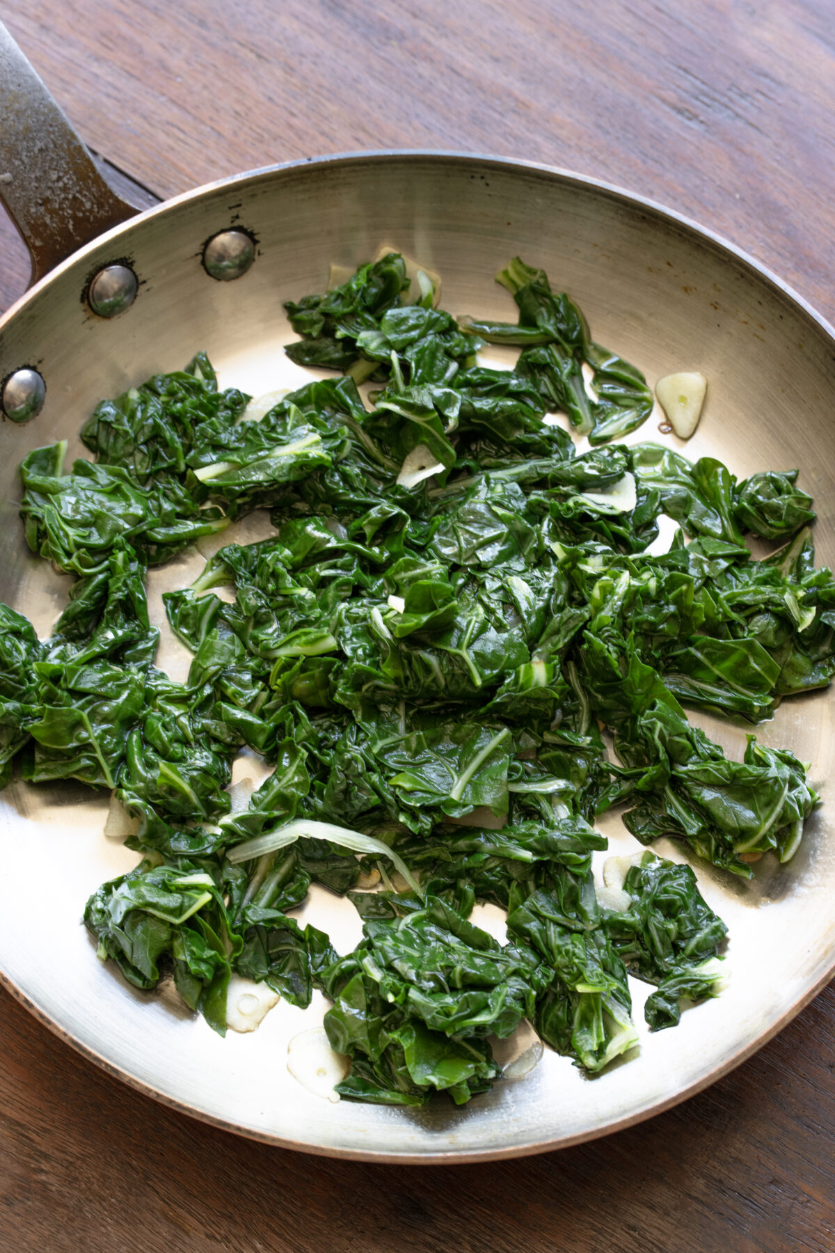 Swiss chard cookingwith the garlic in a large skillet