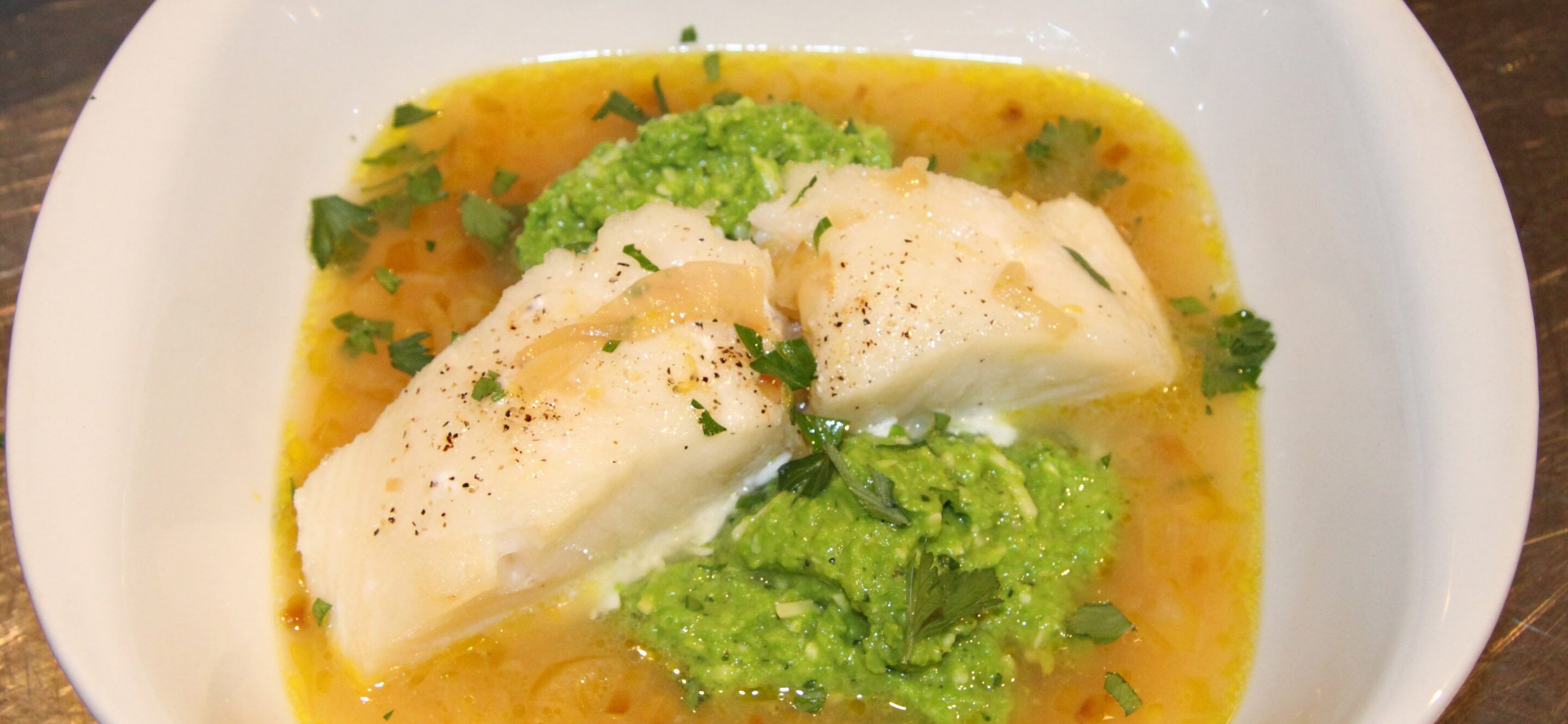 lemon soup with pea puree and sea bass