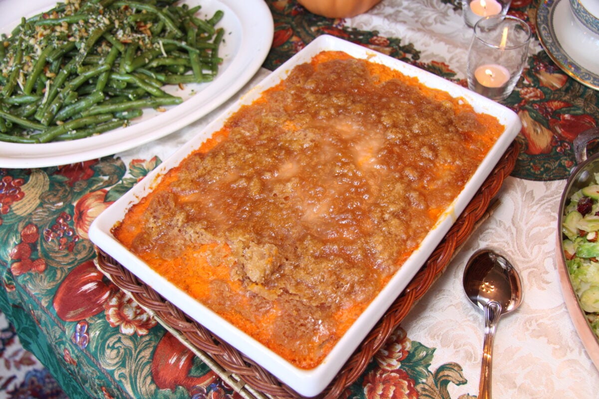 Whipped Sweet Potatoes and Bananas with Honey all baked adn on a holiday table. 