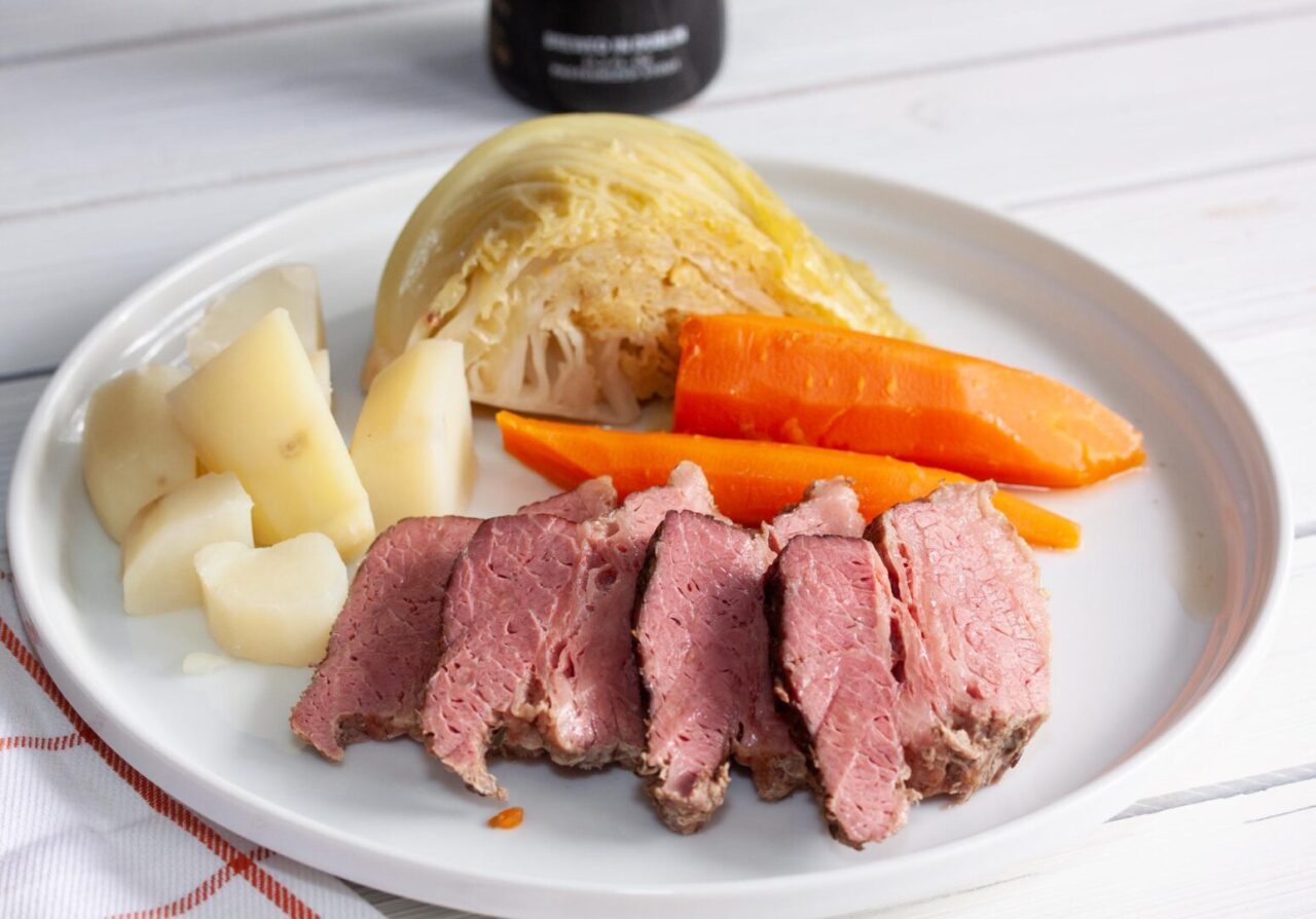 corned beef with horseradish cream sauce on a white plate