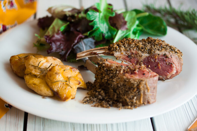 pepper crusted rack of lamb on a serving dish