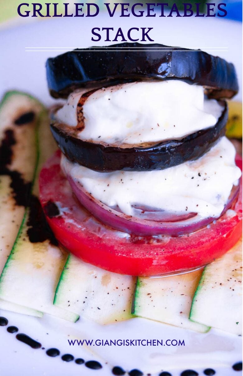 Grilled vegetable stack served on a white serving dish.