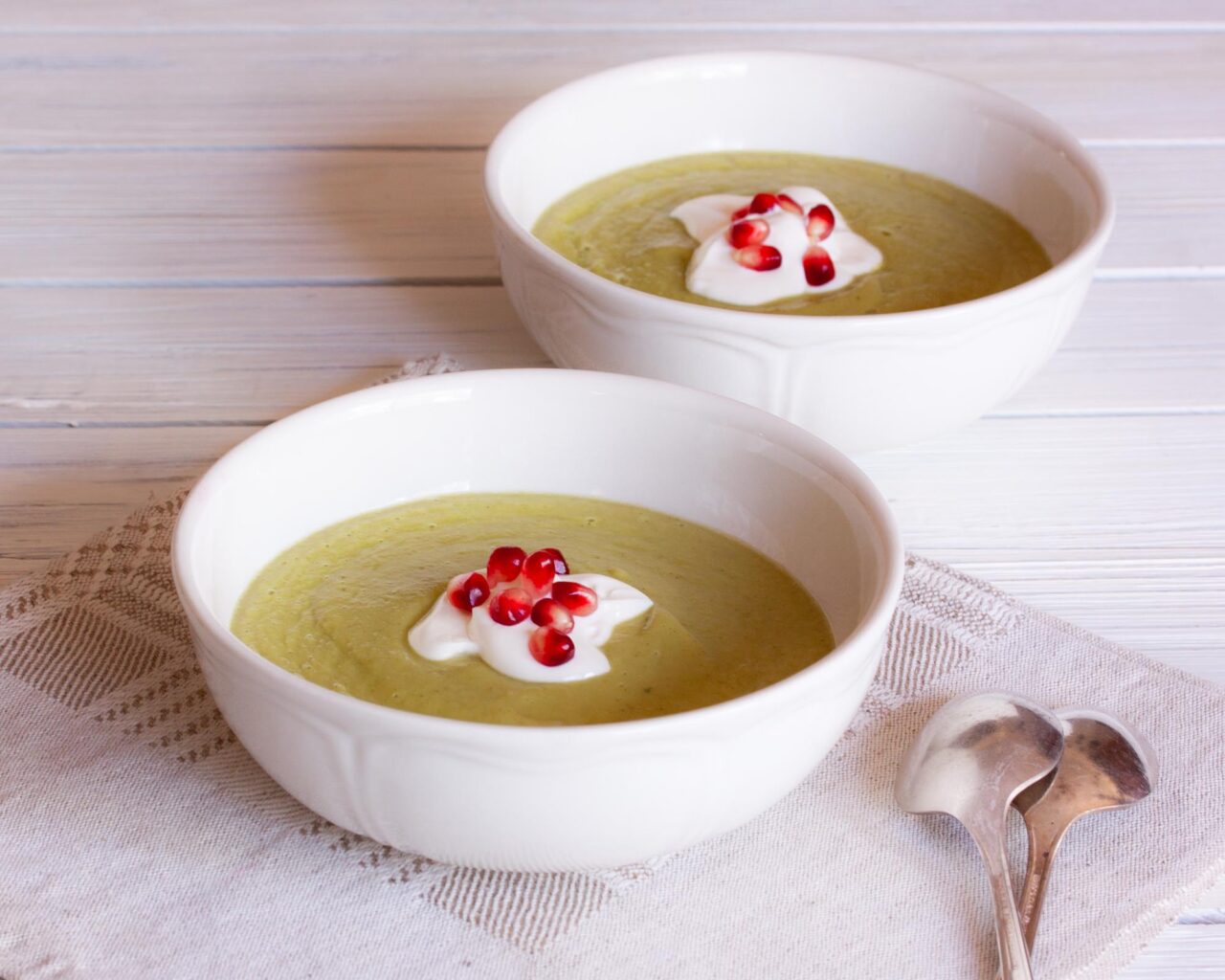 avocado soup served in white bowls