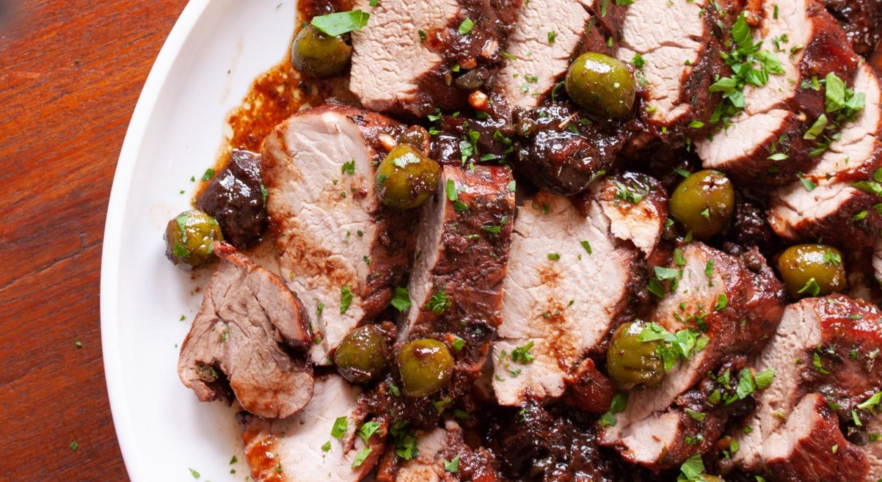 Pork Marbella served in a white plate.