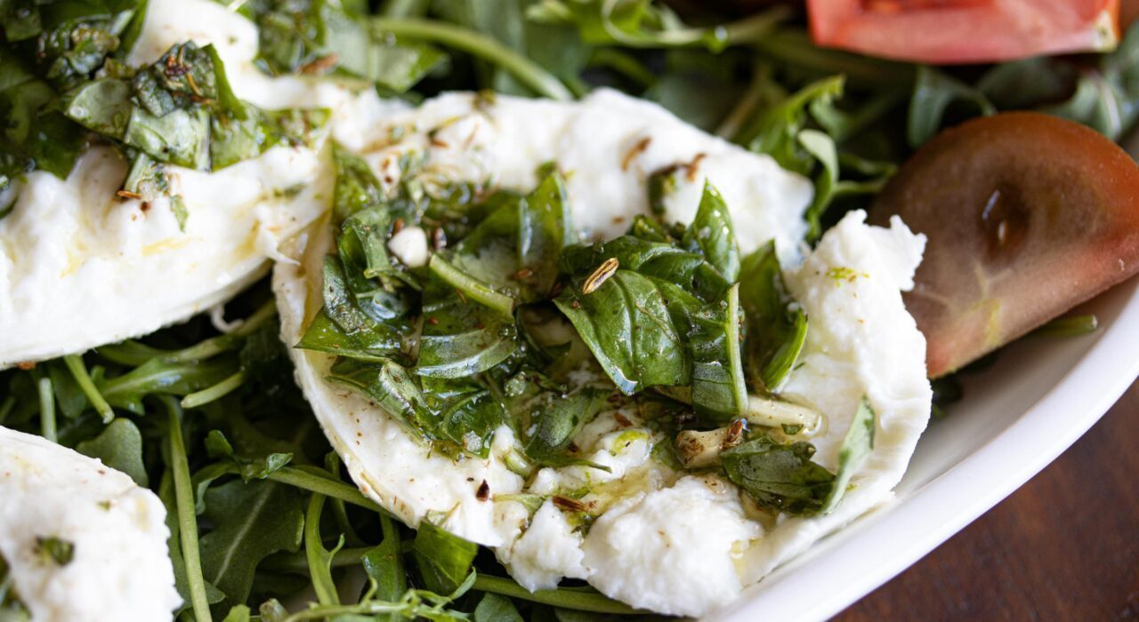 Buffalo mozzarella marinated, with tomatoes and arugula Buffalo mozzarella marinated, with tomatoes and arugula