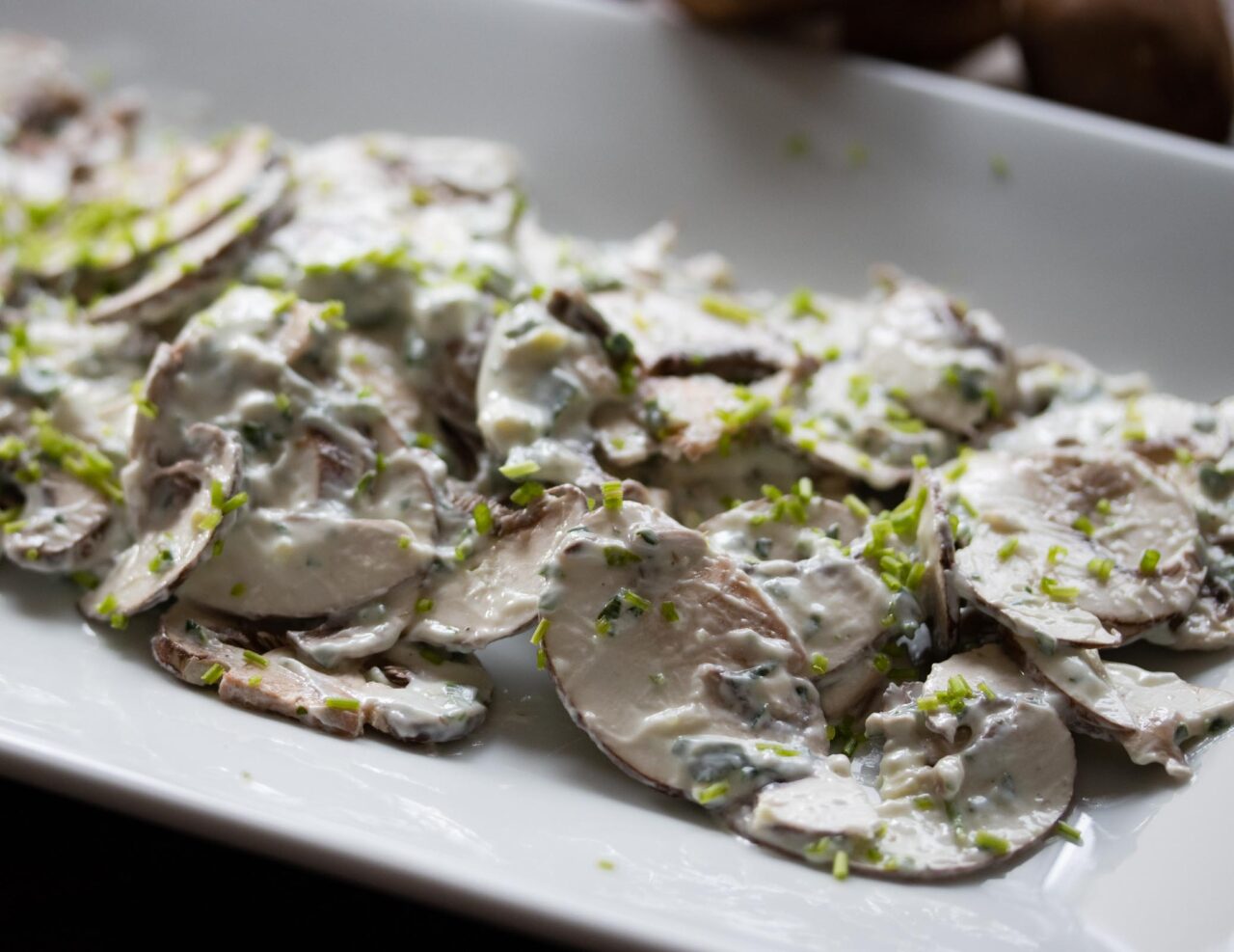 Easy Mushroom Salad With Herbs Side view of the salad on a plate.