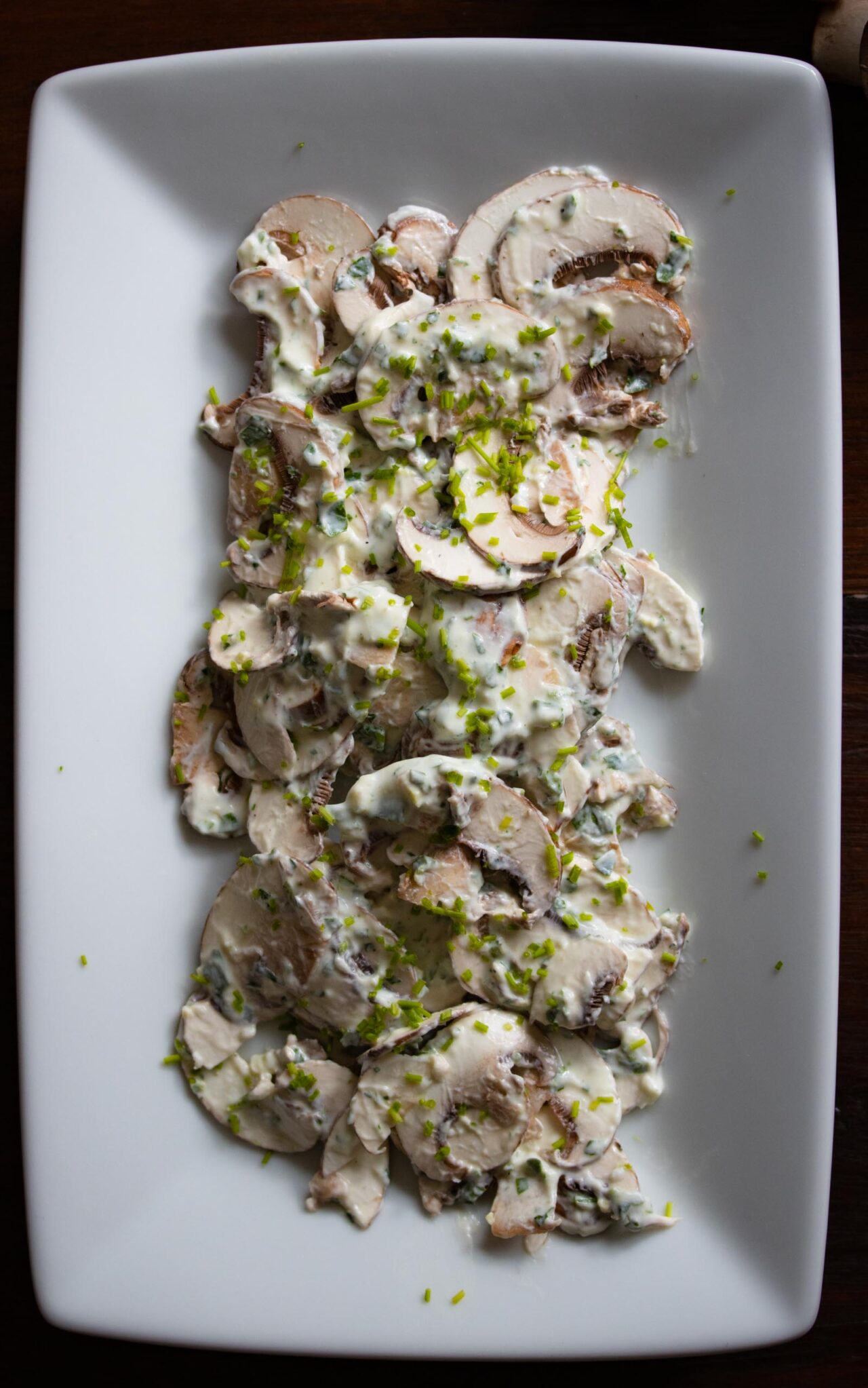Easy Mushroom Salad With Herbs A close up of the salad on a white plate.