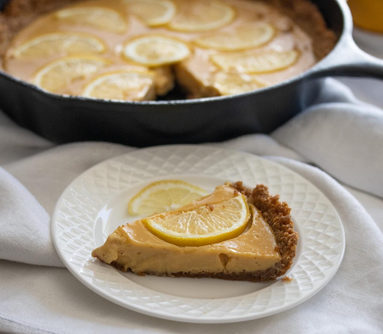 Lemon Tart Tart slice on a white plate.