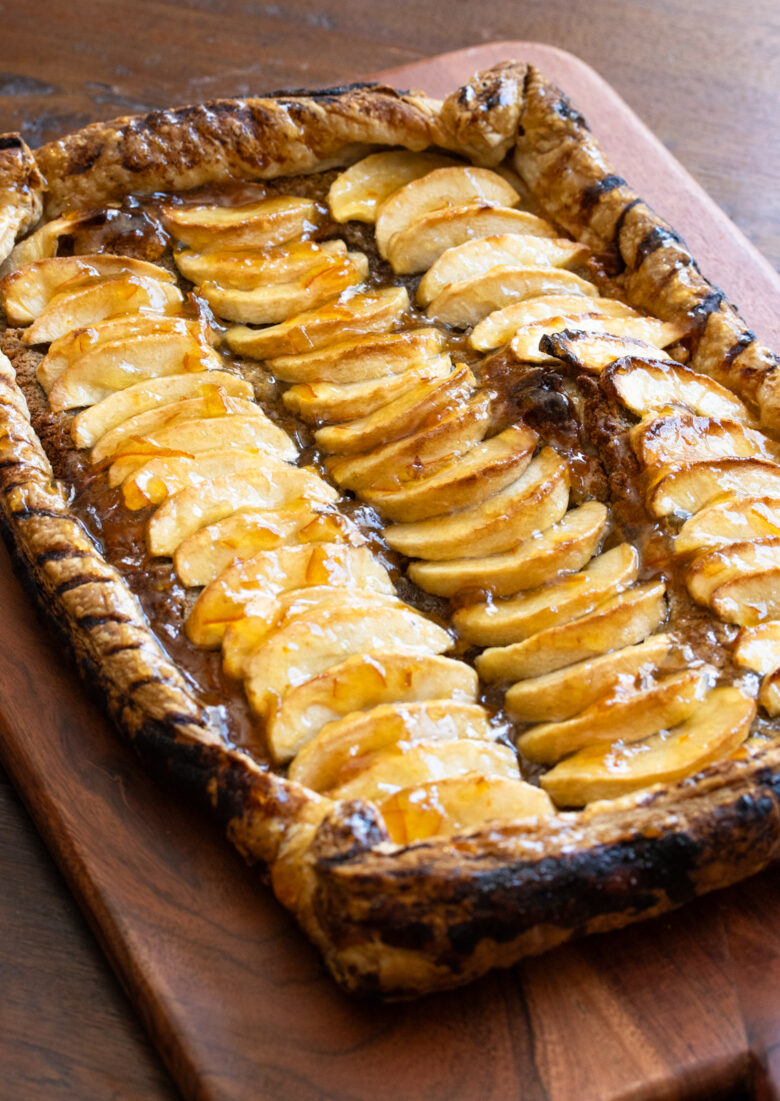 Frangipane tart on a wooden plank ready to be enjoyed.