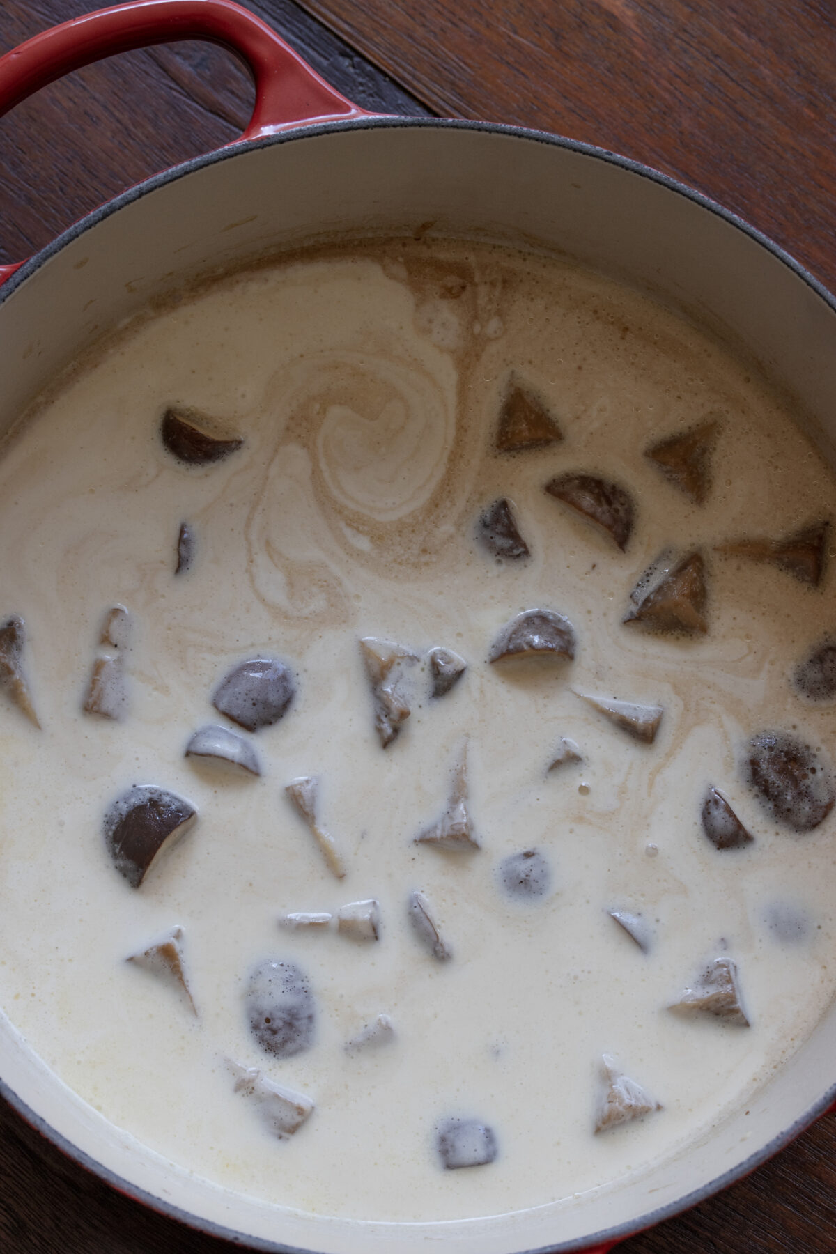 Chicken stock and heavy cream added to the mushroom pan.