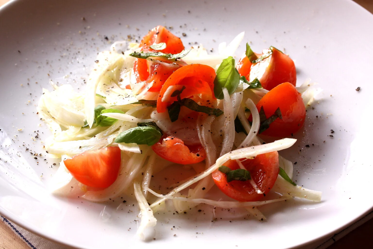 Fennel salad served on a white plate