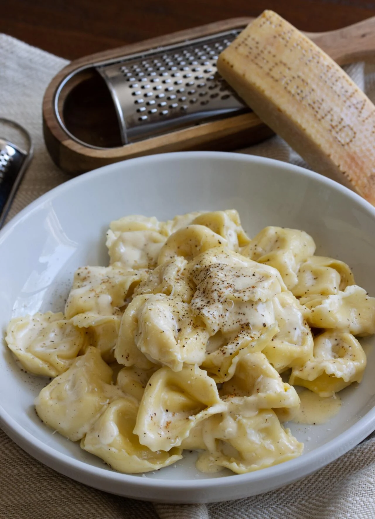 Cheese Tortellini Alfredo The finished cheese tortellini recipe served in a white bowl.