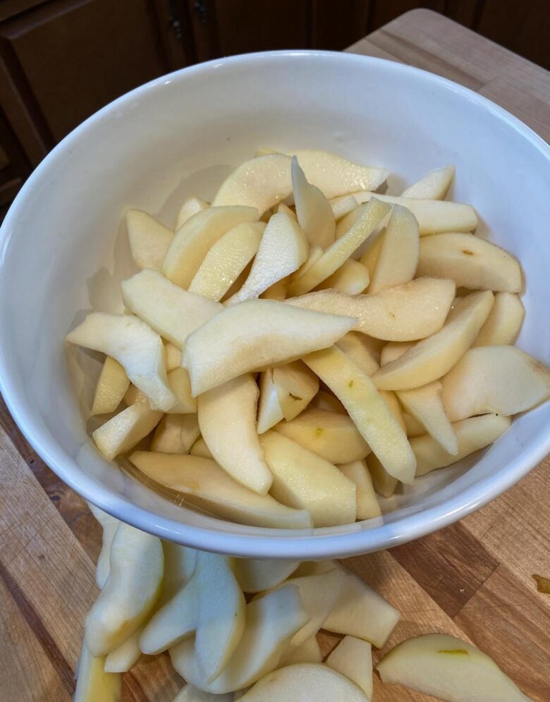 Sliced pears marinating into the brandy.