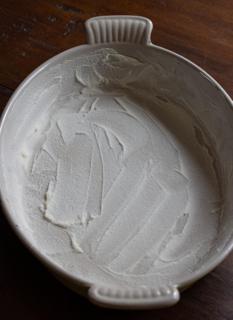 Grating dish prepared with butter and sugar.