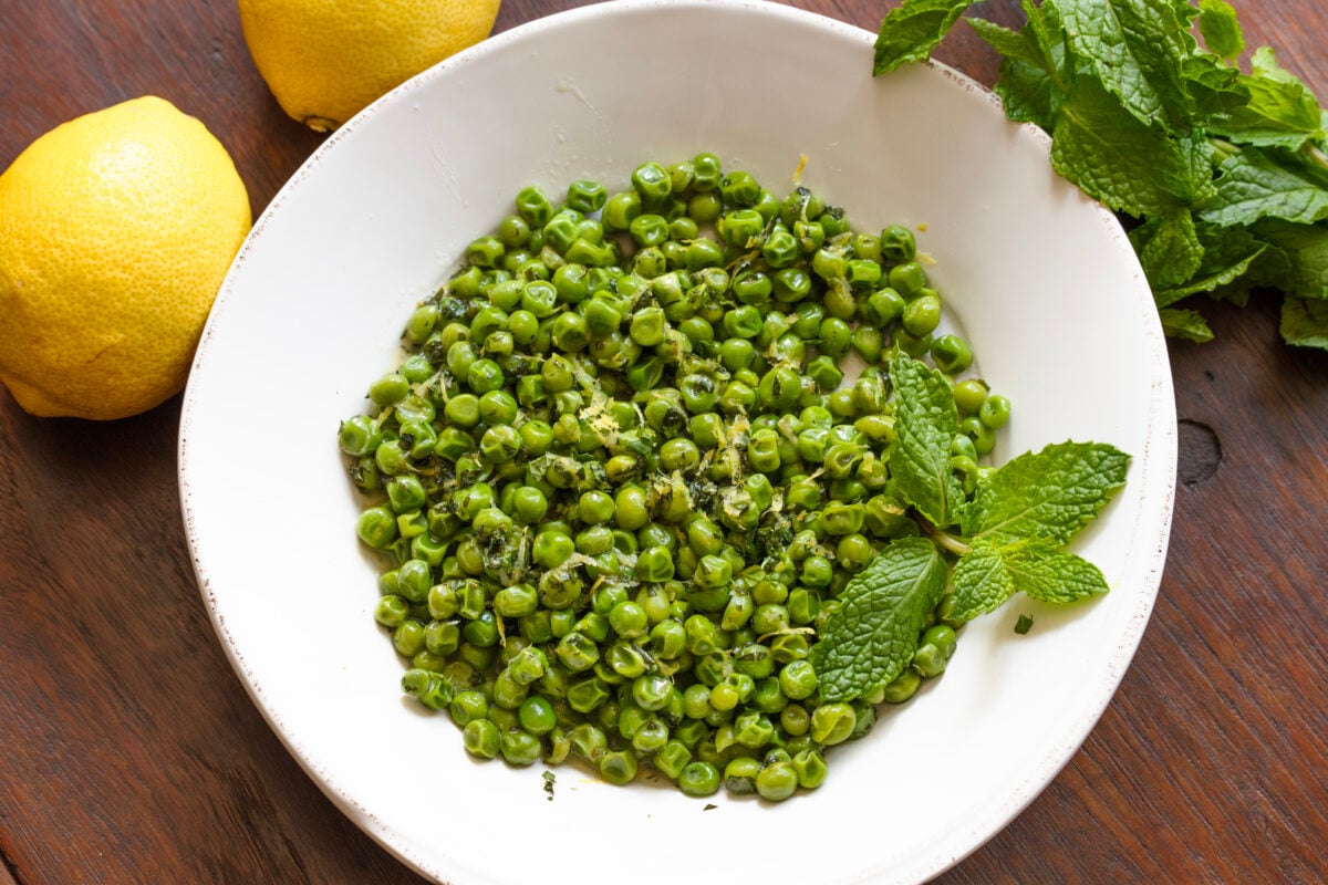 Mint Peas Ready to be enjoyed peas served in a white serving dish.