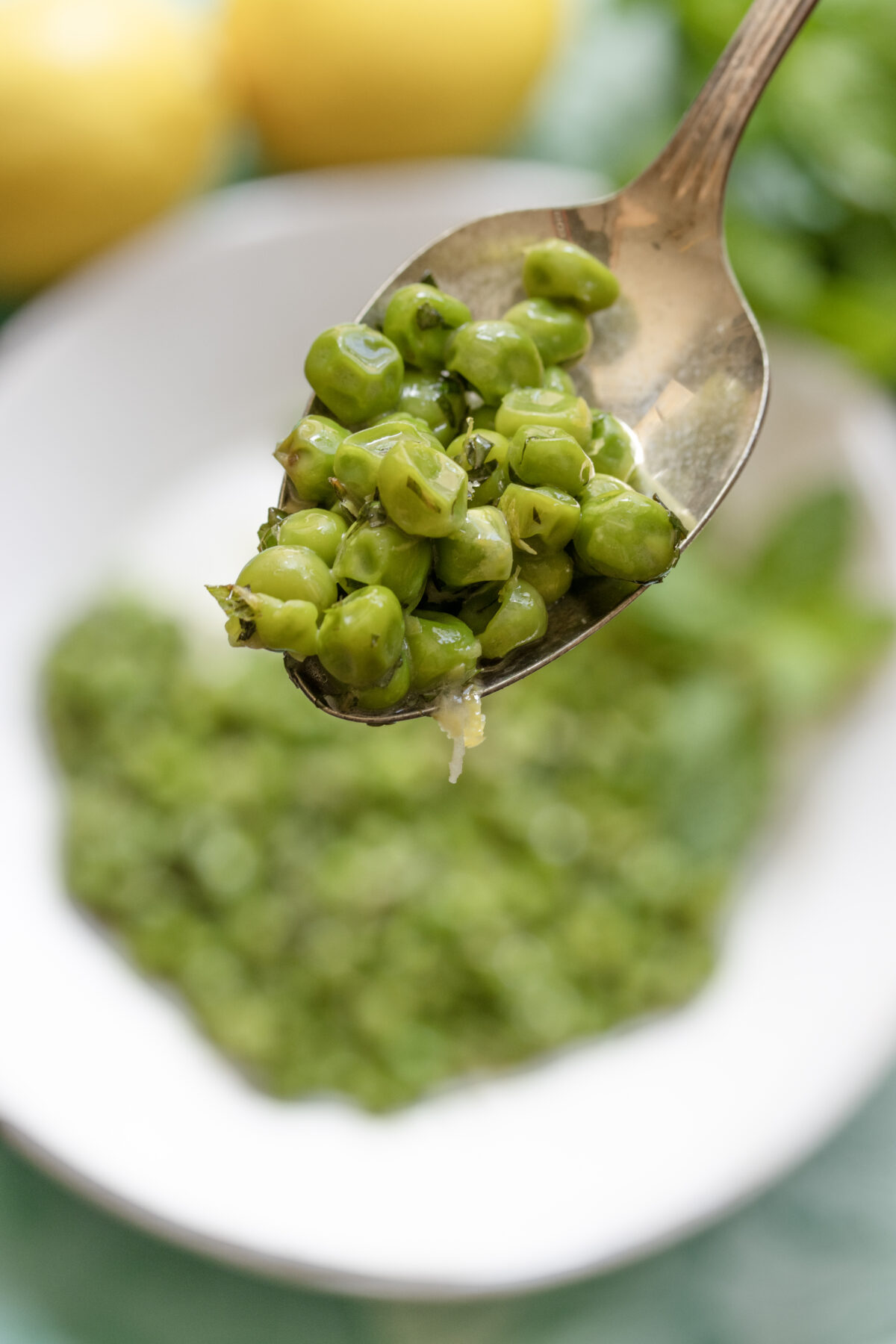 A spoonfull of peas ready to be eaten.