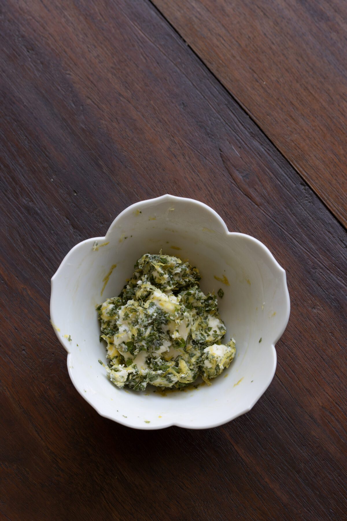 Creating the mint butter by blending mint, butter and lemon zest.