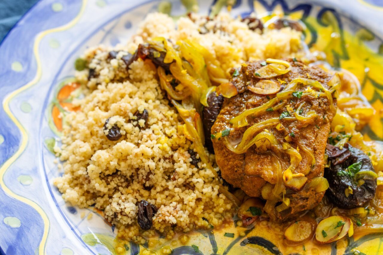 Moroccan Chicken and Prunes served on a painted plate. 