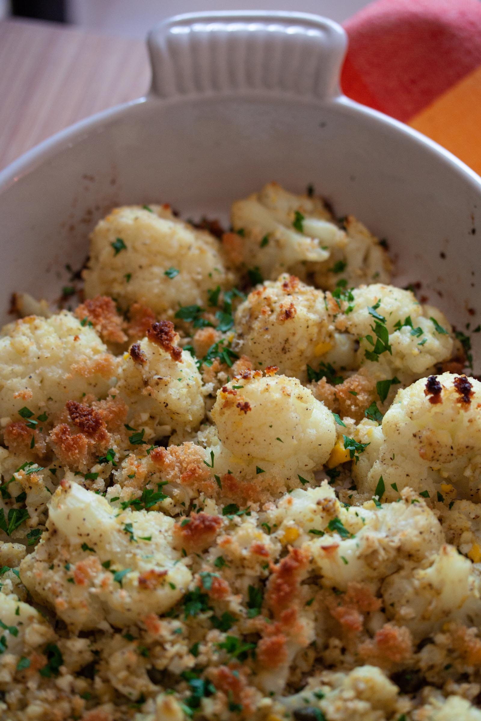 Close up view of the roasted cauliflower in a baking dish.