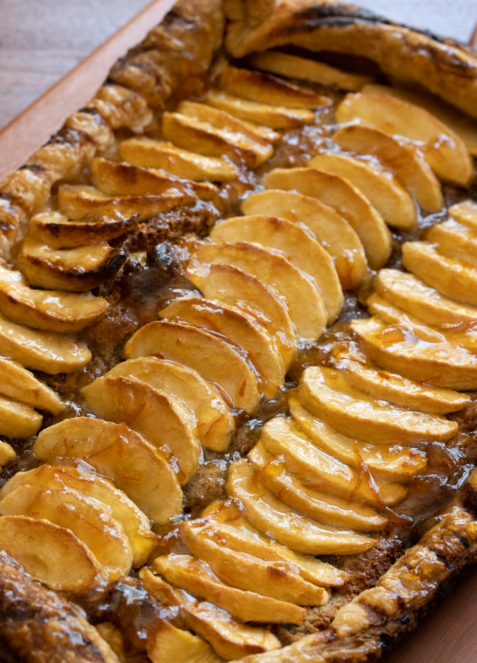 A close up of apple frangipane tarts in a baking tray.