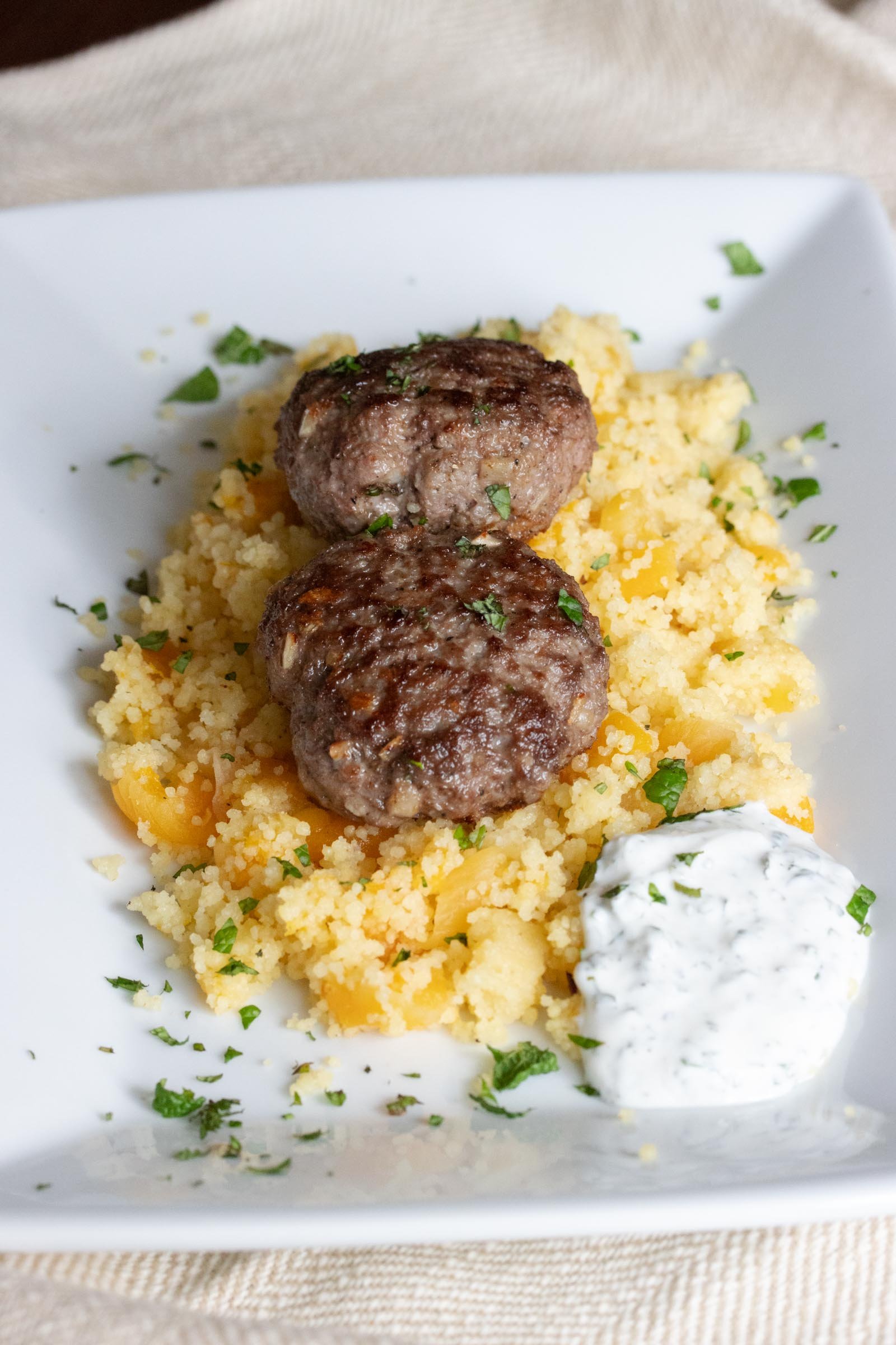 spiced lamb patties and couscous with apricots