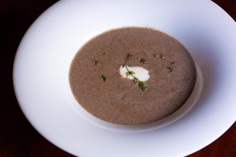 cream of mushrooms soup in a white dish with large rim