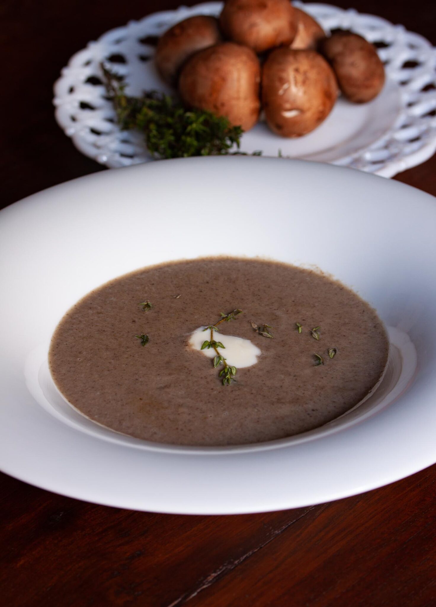 Cream of mushroom soup served on a white plate.