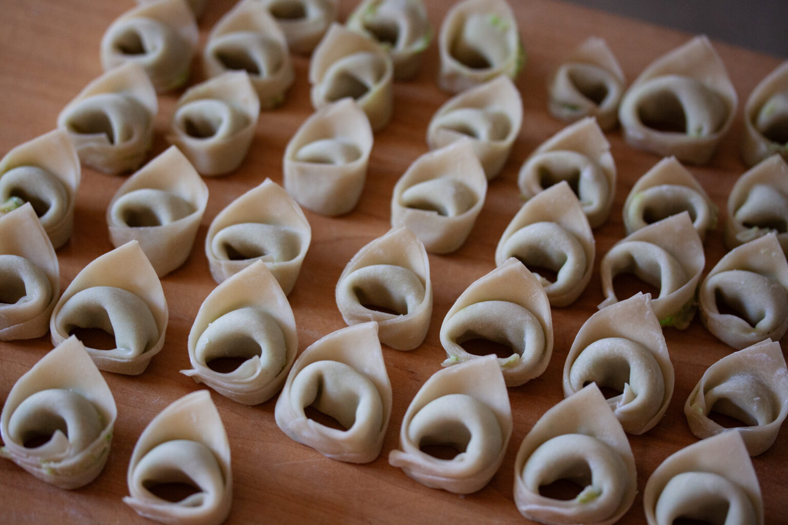 Homemade tortellini ready to be cooked in broth.