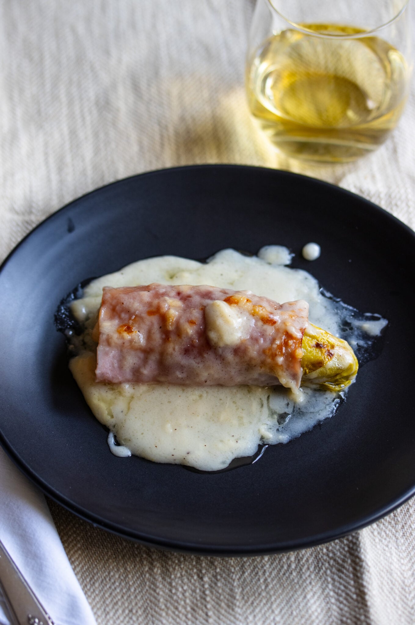 Endive Ham Gratin on a black plate